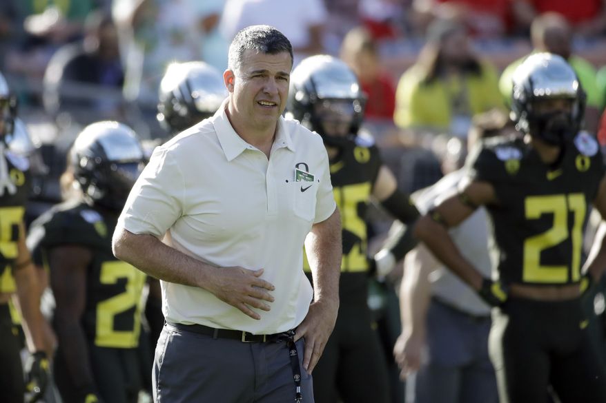 FILE - Oregon head coach Mario Cristobal watches during warm ups before the Rose Bowl NCAA college football game against Wisconsin, in Pasadena, Calif., in this Wednesday, Jan. 1, 2020, file photo. The National Signing Day period begins Wednesday, Feb. 3, 2021. (AP Photo/Marcio Jose Sanchez, File)