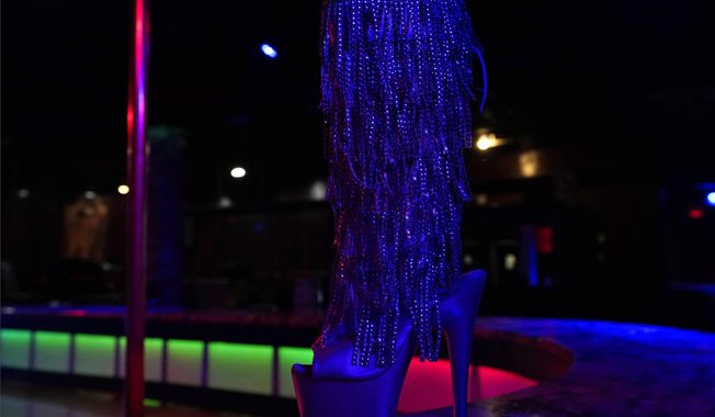 In this file photo, an exotic dancer&#x27;s shoe is shown on the stage at Scores Gentlemen&#x27;s Club Wednesday, Jan. 27, 2021, in Tampa, Fla. A federal appeals court ruled on March 4, 2021, that a bank was correct in denying a loan to a Buffalo, New York-area strip club because federal Paycheck Protection Program rules forbid money going to such operations.  (AP Photo/Chris O&#x27;Meara)