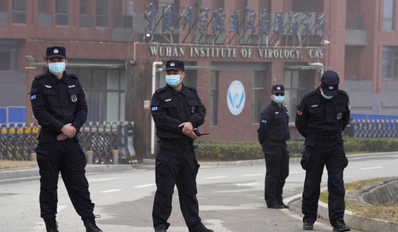 Security personnel gather near the entrance of the Wuhan Institute of Virology during a visit by the World Health Organization team in Wuhan in China&#x27;s Hubei province on Wednesday, Feb. 3, 2021. (AP Photo/Ng Han Guan)