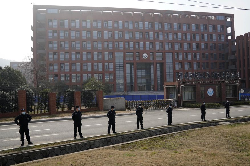 Security personnel gather near the entrance to the Wuhan Institute of Virology during a visit by the World Health Organization team in Wuhan in China&#x27;s Hubei province on Wednesday, Feb. 3, 2021. The WHO team is investigating the origins of the coronavirus pandemic has visited two disease control centers in the province. (AP Photo/Ng Han Guan)