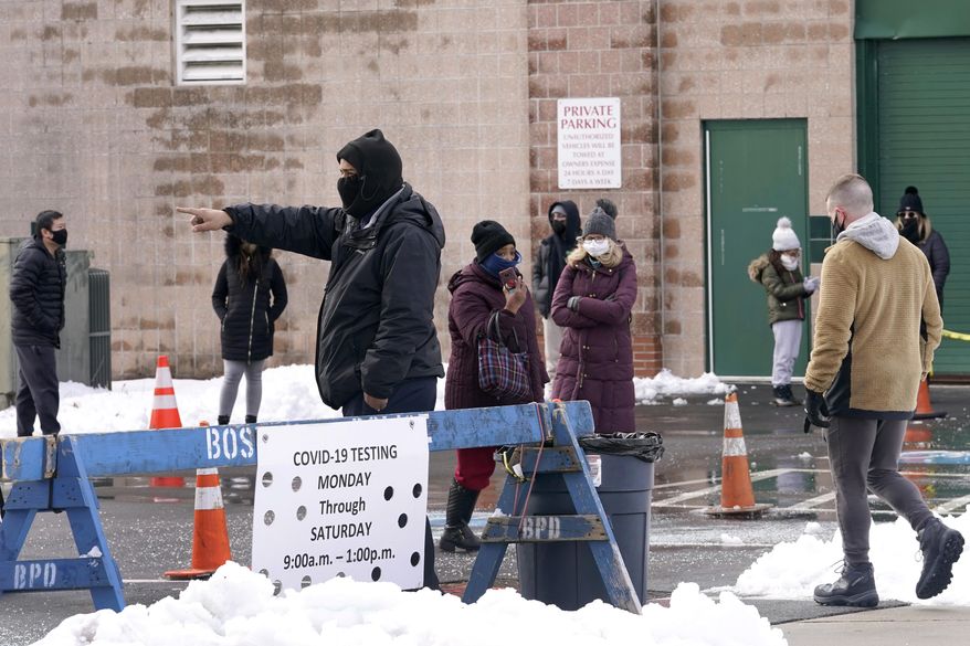 People on line are directed at a COVID-19 testing site, Wednesday, Feb. 3, 2021, in Boston's Roxbury section. (AP Photo/Elise Amendola)