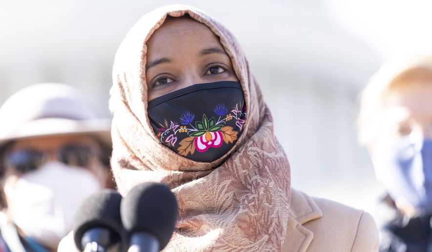Rep. Ilhan Omar, D-Minn., center, accompanied by Sen. Elizabeth Warren, D-Mass., right, and Rep. Alma Adams, D-N.C., left, speaks at a news conference on Capitol Hill in Washington, Thursday, Feb. 4, 2021, about plans to reintroduce a resolution to call on President Biden to take executive action to cancel up to $50,000 in debt for federal student loan borrowers. (AP Photo/Andrew Harnik)
