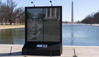 The installation &amp;quot;Vice President Kamala Harris Glass Ceiling Breaker&amp;quot; is seen at the Lincoln Memorial in Washington, Wednesday, Feb. 4, 2021. Vice President Kamala Harris&#39; barrier-breaking career has been memorialized in a portrait depicting her face emerging from the cracks in a massive sheet of glass. Using a photo of Harris that taken by photographer Celeste Sloman, artist Simon Berger lightly hammered on the slab of laminated glass to create the portrait of Harris. The Washington Monument is seen in the distance and the Lincoln Memorial is reflected. (AP Photo/Carolyn Kaster)