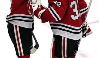 Chicago Blackhawks goalie Kevin Lankinen, right, is congratulated by Duncan Keith after the team&#x27;s win over the Carolina Hurricanes in an NHL hockey game in Chicago, Thursday, Feb. 4, 2021. (AP Photo/Nam Y. Huh)