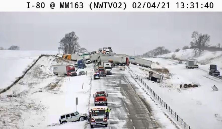 This image provided by the Iowa Transportation Department from a traffic camera shows a massive pileup on Interstate 80, Thursday, Feb. 4, 2021, west of Newton, Iowa. A snowy section of Interstate 80 was closed Thursday afternoon in central Iowa, after the massive crash involving roughly 40 vehicles. Iowa authorities closed the eastbound lanes of the interstate west of Newton after the chain-reaction crash. (Iowa Transportation Department via AP)