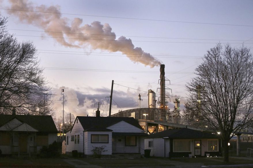 In an undated file photo, smoke billows from a Marathon Petroleum refinery near a neighborhood in southwest Detroit. The Donors of Color, a philanthropic group dedicated to pushing for racial equity in funding environmental projects nationwide, has launched a pledge drive challenging the nation’s top climate funders to shift 30% of their donations toward environmental efforts led by Black, Indigenous and other people of color. (Romain Blanquart/Detroit Free Press via AP)