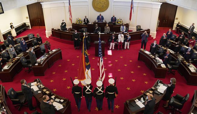 A Marine color guard marches into the Senate chamber during the opening session of the North Carolina General Assembly in Raleigh, N.C., Wednesday, Jan. 13, 2021. (AP Photo/Gerry Broome)