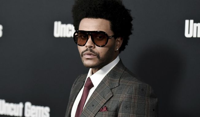 FILE - The Weeknd attends the LA premiere of &amp;quot;Uncut Gems&amp;quot; at ArcLight Hollywood on Wednesday, Dec. 11, 2019, in Los Angeles. The Weeknd may be known for his graphic music videos and performances featuring blood and violence, but the three-time Grammy winner says he will tone down his act during the Super Bowl halftime show. (Photo by Richard Shotwell/Invision/AP, File)
