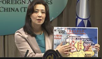 In this image made from video, Taiwan&#39;s Ministry of Foreign Affairs spokesperson Joanne Ou points at a map of Guyana at a weekly press conference, Thursday, Feb. 4, 2021, in Taipei, Taiwan. Taiwan has established a trade office in the South American country of Guyana, a diplomatic win for the island which has continued to lose allies in an aggressive poaching campaign from China in recent years. (AP Photo)