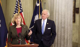 South Carolina Education Superintendent Molly Spearman, left, and Gov. Henry McMaster, right, talk about a Senate proposal to get teachers COVID-19 vaccines immediately on Thursday, Feb. 4, 2021, in Columbia, S.C. McMaster is against the plan. (AP Photo/Jeffrey Collins)
