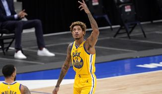 Golden State Warriors&#39; Kelly Oubre Jr. (12) celebrates a 3-point basket during the second half of the team&#39;s NBA basketball game against the Dallas Mavericks in Dallas, Thursday, Feb. 4, 2021. (AP Photo/Tony Gutierrez)