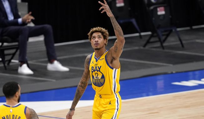 Golden State Warriors&#x27; Kelly Oubre Jr. (12) celebrates a 3-point basket during the second half of the team&#x27;s NBA basketball game against the Dallas Mavericks in Dallas, Thursday, Feb. 4, 2021. (AP Photo/Tony Gutierrez)