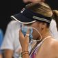United States&#39; Sofia Kenin holds a mask to her face during her match against Spain&#39;s Garbine Muguruza at a tuneup event ahead of the Australian Open tennis championships in Melbourne, Australia, Friday, Feb. 5, 2021.(AP Photo/Andy Brownbill)