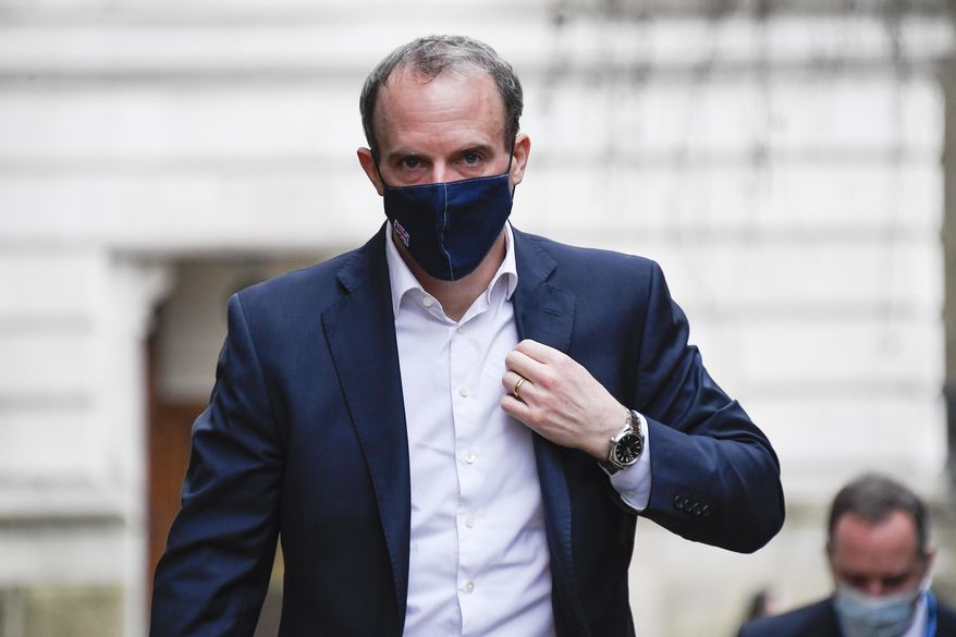 Britain&#39;s Foreign Secretary Dominic Raab wears a face mask as he arrives at 10 Downing Street, in London, Wednesday, Feb. 3, 2021.(AP Photo/Alberto Pezzali)