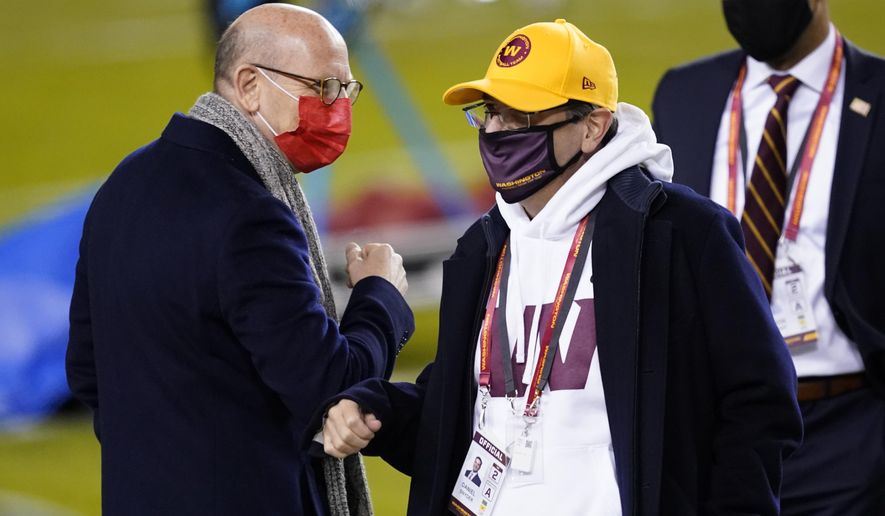 Tampa Bay Buccaneers owner Joel Glazer, left, talks with Washington Football Team owner Daniel Snyder, right, before an NFL wild-card playoff football game Saturday, Jan. 9, 2021, in Landover, Md. (AP Photo/Andrew Harnik)