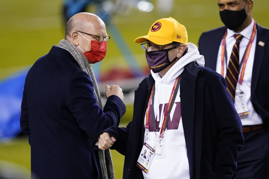 Tampa Bay Buccaneers owner Joel Glazer, left, talks with Washington Football Team owner Daniel Snyder, right, before an NFL wild-card playoff football game Saturday, Jan. 9, 2021, in Landover, Md. (AP Photo/Andrew Harnik)