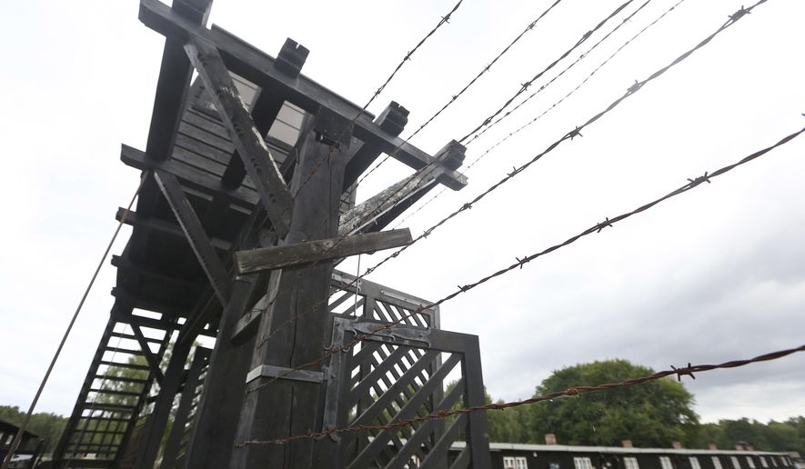 FILE - In this July 18, 2017 file photo, the wooden main gate leads into the former Nazi German Stutthof concentration camp in Sztutowo, Poland. (AP Photo/Czarek Sokolowski, file)