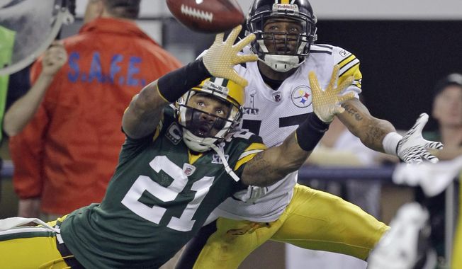 FILE - In this Feb. 6, 2011, file photo, Green Bay Packers&#x27; Charles Woodson (21) defends on a pass intended for Pittsburgh Steelers&#x27; Mike Wallace during the first half of the NFL football Super Bowl XLV football game in Arlington, Texas, in this Sunday, Feb. 6, 2011, file photo. The pass fell incomplete. Charles Woodson beat out Peyton Manning for a prestigious college award. Something called the Heisman Trophy. On Saturday, Feb. 6, 2021, they likely will share an even more impressive football honor: entry into the Pro Football Hall of Fame. (AP Photo/Dave Martin, File)