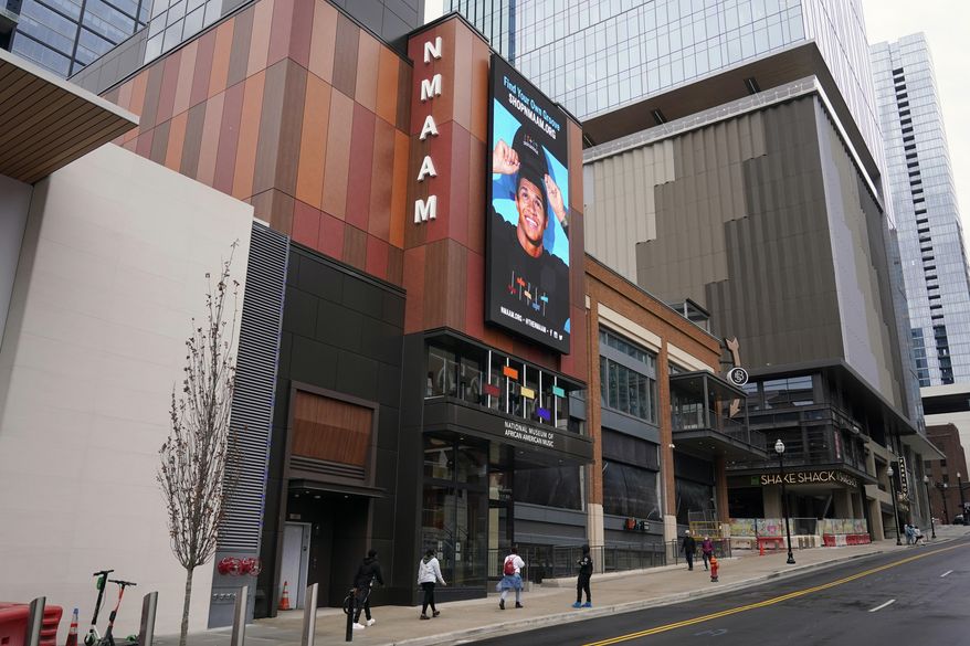 People walk to the entrance of the National Museum of African American Music, Saturday, Jan. 30, 2021, in Nashville, Tenn. Unlike other museums that focus on a genre or label, this new museum is the first to span multiple genres including gospel, blues, jazz, R&B and hip hop. (AP Photo/Mark Humphrey)
