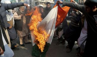 Pakistani traders burn a representation of Indian flag during demonstration to mark Kashmir Solidarity Day, in Peshawar, Pakistan, Friday, Feb. 5, 2021. Pakistan&#39;s political and military leadership on Friday marked the annual Day of Solidarity with Kashmir, vowing to continue political support for those living in the Indian-controlled part of Kashmir and for a solution to the disputed region&#39;s status in accordance with U.N. resolutions. (AP Photo/Muhammad Sajjad)