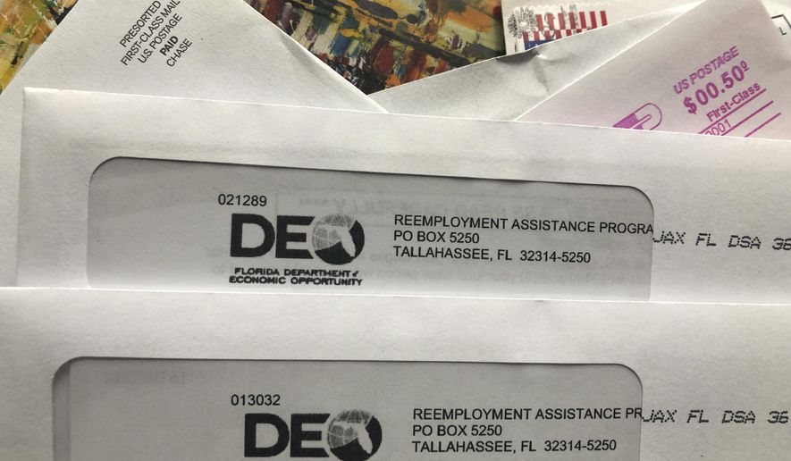 Envelopes from the Florida Department of Economic Opportunity Reemployment Assistance Program are shown, Thursday, Nov. 5, 2020, in Surfside, Fla.  The number of a Americans applying for unemployment benefits rose last week to 778,000, evidence that the U.S. economy and job market remain under strain as coronavirus cases surge and colder weather heighten the risks.  (AP Photo/Wilfredo Lee)