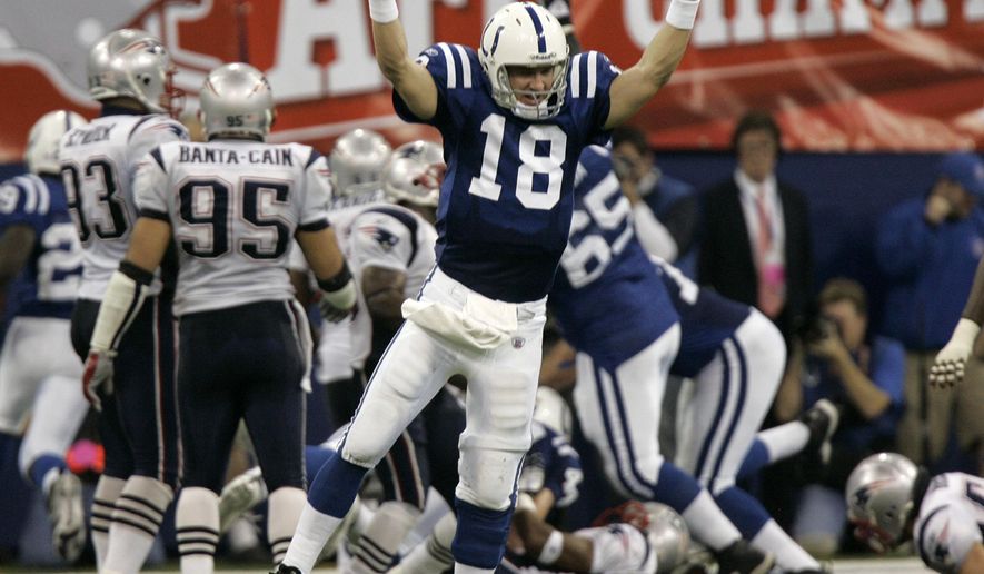 FILE - In this Jan. 21, 2007, file photo, Indianapolis Colts quarterback Peyton Manning (18) celebrates running back Joseph Addai&#39;s three-yard touchdown run in the fourth quarter of the AFC Championship football game against the New England Patriots, in Indianapolis. Charles Woodson beat out Peyton Manning for a prestigious college award. Something called the Heisman Trophy. On Saturday, Feb. 6, 2021, they likely will share an even more impressive football honor: entry into the Pro Football Hall of Fame. (AP Photo/Amy Sancetta, File)