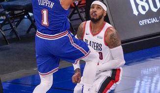 New York Knicks forward Obi Toppin (1) goes to the basket over Portland Trail Blazers forward Carmelo Anthony (00) during the first half of an NBA basketball game, Saturday, Feb. 6, 2021, in New York. (AP Photo/Mary Altaffer, Pool)