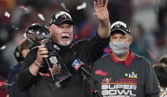 Tampa Bay Buccaneers head coach Bruce Arians holds up the Vince Lombardi trophy after defeating the Kansas City Chiefs in the NFL Super Bowl 55 football game Sunday, Feb. 7, 2021, in Tampa, Fla. The Buccaneers defeated the Chiefs 31-9 to win the Super Bowl. (AP Photo/Ashley Landis)