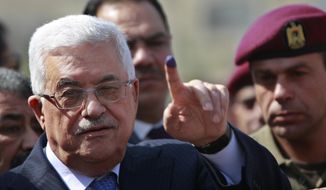 File - In this Saturday, Oct. 20, 2012 file photo, palestinian President Mahmoud Abbas shows his ink-stained finger after casting his vote during local elections at a polling station in the West Bank city of Ramallah. President Abbas called for legislative elections on May 22 and presidential elections on July 31, 2021. (AP Photo/Majdi Mohammed, File)
