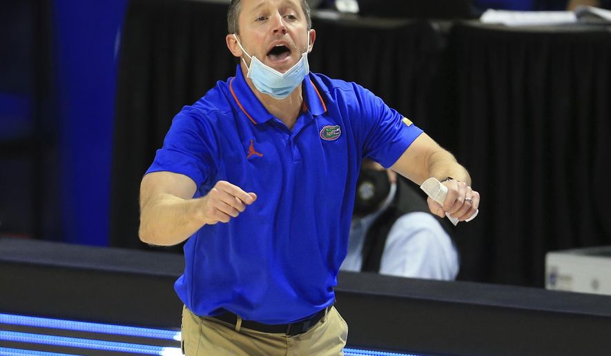 Florida coach Mike White shouts to the team during the first half of an NCAA college basketball game against South Carolina on Wednesday, Feb. 3, 2021, in Gainesville, Fla. (AP Photo/Matt Stamey)