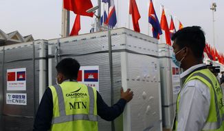 Workers pull boxes loaded with COVID-19 vaccines before a handing over ceremony at Phnom Penh International Airport, in Phnom Penh, Cambodia, Sunday, Feb. 7, 2021. Cambodia on Sunday received its first shipment of COVID-19 vaccine, a donation of 600,000 doses from China, the country&#39;s biggest ally. Beijing has been making such donations to several Southeast Asian and African nations in what has been dubbed &amp;quot;vaccine diplomacy,&amp;quot; aimed especially at poorer countries like Cambodia. (AP Photo/Heng Sinith)