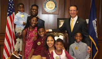 Louisiana Attorney General Jeff Landry poses with Nyron Harrison and his family. )Photo courtesy Louisiana attorney general&#39;s office.)