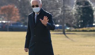 President Joe Biden waves to reporters as he arrives on the South Lawn of the White House, Monday, Feb. 8, 2021, in Washington. (AP Photo/Evan Vucci)
