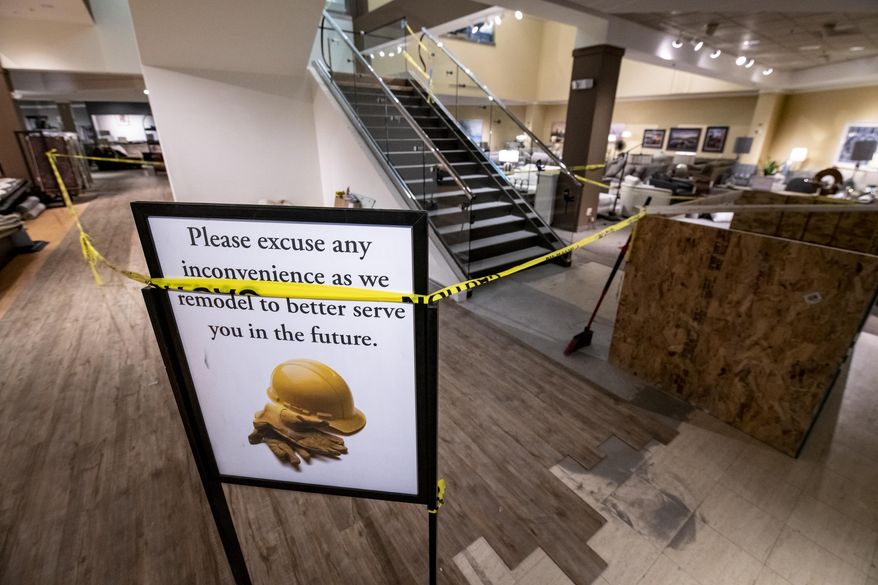 The 1986 escalator at HOM Furniture in downtown Sioux City, Iowa, is being replaced by a set of stairs shown under construction on Jan. 30, 2021. The escalator had been in constant use since the downtown space at 415 4th St. was occupied by a Younkers department store. (Jesse Brothers/Sioux City Journal via AP)