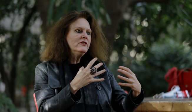 German Monika Borgmann, wife of Lokman Slim, a well-known Lebanese publisher and vocal critic of Hezbollah, the Lebanese Shiite Muslim political party, which has an armed wing of the same name, who was killed Thursday, speaks during an interview at her house in the southern Beirut suburb of Dahiyeh, Lebanon, Monday, Feb. 8, 2021. Borgmann said she is discussing with lawyers and friends how to push for an international investigation into her husband&#x27;s murder. (AP Photo/Bilal Hussein)