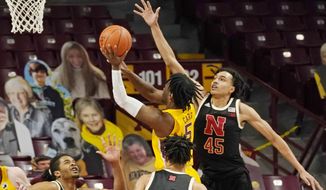 Minnesota&#39;s Marcus Carr (5) shoots as Nebraska&#39;s Dalano Banton (45) defends in the second half of an NCAA college basketball game, Monday, Feb. 8, 2021, in Minneapolis. Carr led Minnesota with 21 points. (AP Photo/Jim Mone)