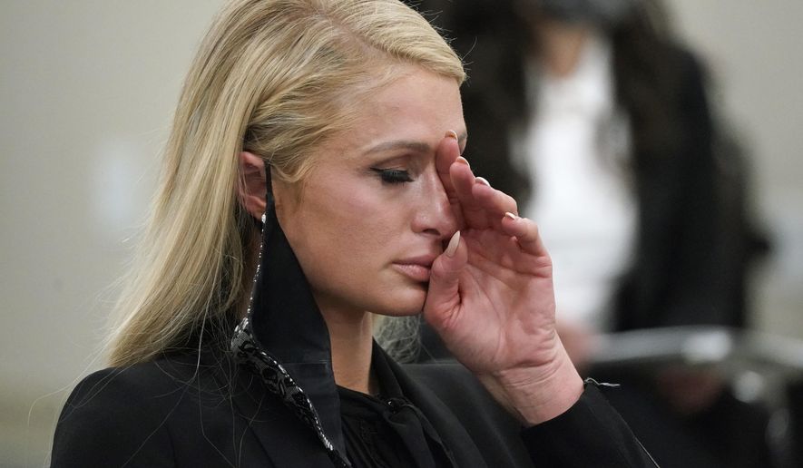 Paris Hilton wipes her eyes after speaking at a committee hearing at the Utah State Capitol, Monday, Feb. 8, 2021, in Salt Lake City. Hilton has been speaking out about abuse she says she suffered at a boarding school in Utah in the 1990s and she testified in front of state lawmakers weighing new regulations for the industry. (AP Photo/Rick Bowmer)