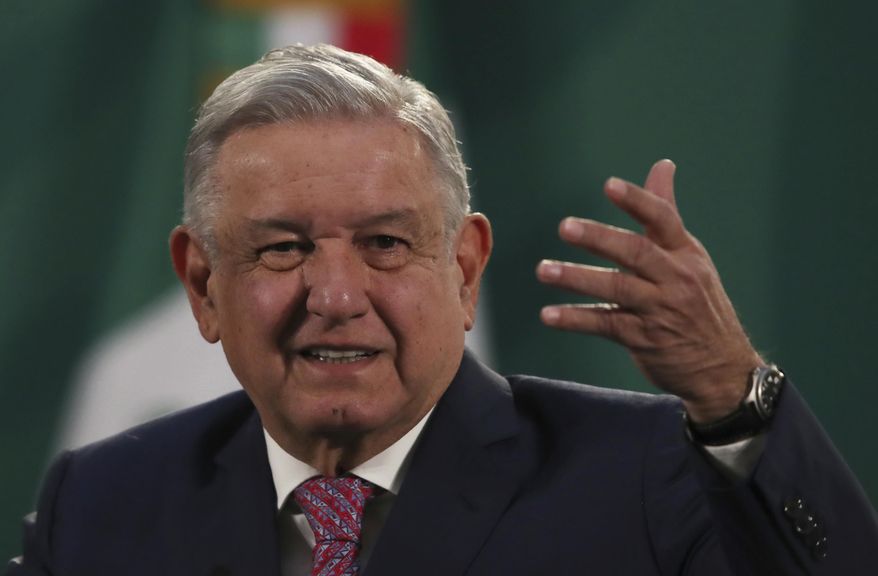 Mexican President Andrés Manuel López Obrador gives his daily morning press conference following a two-week absence after he tested positive for coronavirus, at the presidential palace, Palacio Nacional, in Mexico City, Monday, Feb. 8, 2021. (AP Photo/Marco Ugarte)