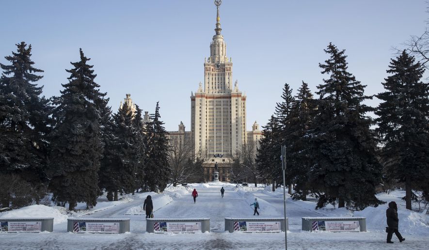 People walk towards the main building of the Moscow State University in Moscow, Russia, Monday, Feb. 8, 2021. Students of Moscow's Universities returned to continued their studies on site. (AP Photo/Pavel Golovkin)