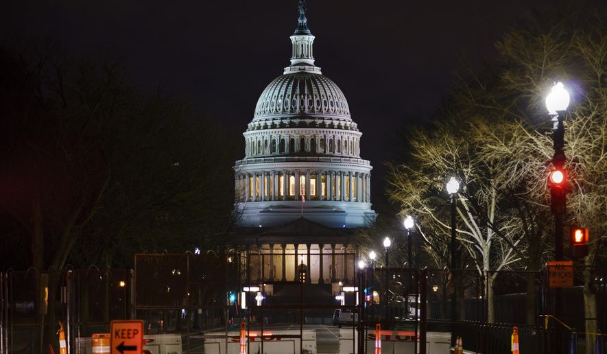 The Capitol is seen behind reinforced barricades as the second impeachment trial of former President Donald Trump begins in the Senate in Washington, Tuesday, Feb. 9, 2021. Trump was charged by the House with incitement of insurrection for his role in agitating a violent mob of his supporters that laid siege to the U.S. Capitol on Jan. 6, and sent members of Congress into hiding as they met to validate President Joe Biden&#39;s victory. (AP Photo/J. Scott Applewhite)