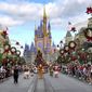 In this Dec. 21, 2020, file photo, crowds line Main Street USA, with Cinderella Castle on the horizon, to watch characters parade at the Magic Kingdom at Walt Disney World, in Lake Buena Vista, Fla. (Joe Burbank/Orlando Sentinel via AP, File)
