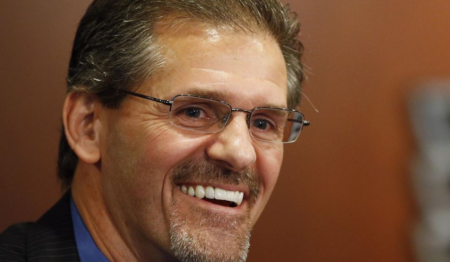 FILE - In this May 7, 2014, file photo, Philadelphia Flyers general manager Ron Hextall laughs during an NHL hockey news conference in Philadelphia. Mario Lemieux and the Pittsburgh Penguins are turning to a former rival to help them keep the Stanley Cup window open for Sidney Crosby and company. The team hired former Philadelphia Flyer goaltender and general manager Ron Hextall as the team&#39;s general manager on Tuesday, Feb. 9, 2021. (AP Photo/Matt Slocum, File)