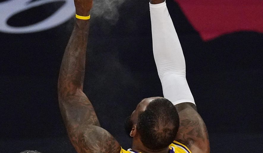 Los Angeles Lakers forward LeBron James throws powder in the air prior to an NBA basketball game against the Oklahoma City Thunder Monday, Feb. 8, 2021, in Los Angeles. (AP Photo/Mark J. Terrill)