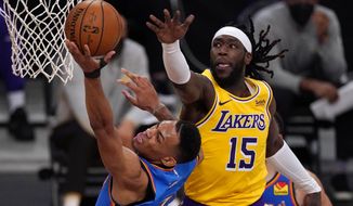 Oklahoma City Thunder forward Darius Bazley, left, shoots as Los Angeles Lakers center Montrezl Harrell defends during the second half of an NBA basketball game Monday, Feb. 8, 2021, in Los Angeles. The Lakers won 119-112 in overtime. (AP Photo/Mark J. Terrill)