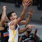 Golden State Warriors guard Stephen Curry (30) scores past San Antonio Spurs forward Keldon Johnson, left, and forward Rudy Gay, right, during the second half of an NBA basketball game in San Antonio, Tuesday, Feb. 9, 2021. (AP Photo/Eric Gay)