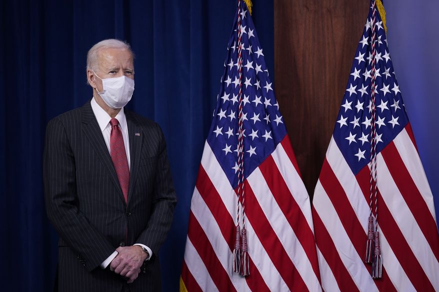 President Joe Biden waits to speak to Department of Defense personnel alongside Vice President Kamala Harris and Defense Secretary Lloyd Austin at the Pentagon, Wednesday, Feb. 10, 2021, in Washington. (AP Photo/Patrick Semansky)