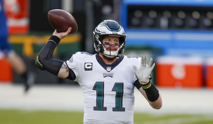 Philadelphia Eagles&#39; Carson Wentz warms up before an NFL football game against the Green Bay Packers in Green Bay, Wis., in this  Sunday, Dec. 6, 2020, file photo. The Matthew Stafford-Jared Goff trade not only has whet fans&#39; appetites for big deals, it&#39;s caused a social media frenzy about which quarterbacks are headed elsewhere. (AP Photo/Matt Ludtke, File)  **FILE**
