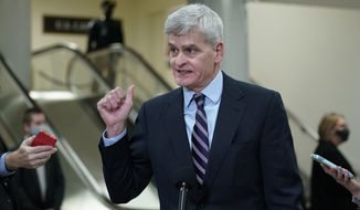 Sen. Bill Cassidy, R-La., talks with reporters on Capitol Hill in Washington, Wednesday, Feb. 10, 2021, as he heads to the second day of the second impeachment trial of former President Donald Trump. (AP Photo/Susan Walsh)