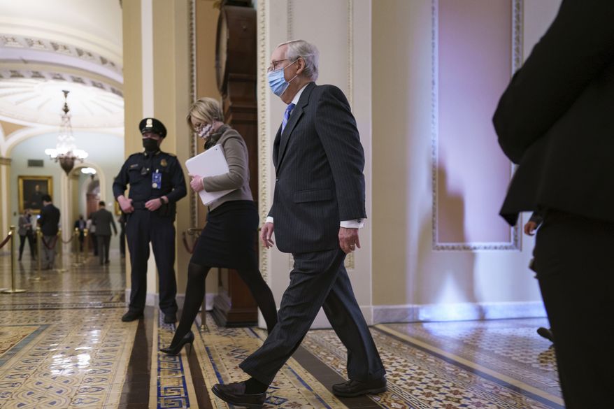 Senate Minority Leader Mitch McConnell, R-Ky., returns to the chamber for the second impeachment trial of former President Donald Trump, at the Capitol in Washington, Tuesday, Feb. 9, 2021. Trump was charged by the House with incitement of insurrection for his role in agitating a violent mob of his supporters that laid siege to the U.S. Capitol on Jan. 6, sending members of Congress into hiding as the Electoral College met to validate President Joe Biden's victory. (AP Photo/J. Scott Applewhite)