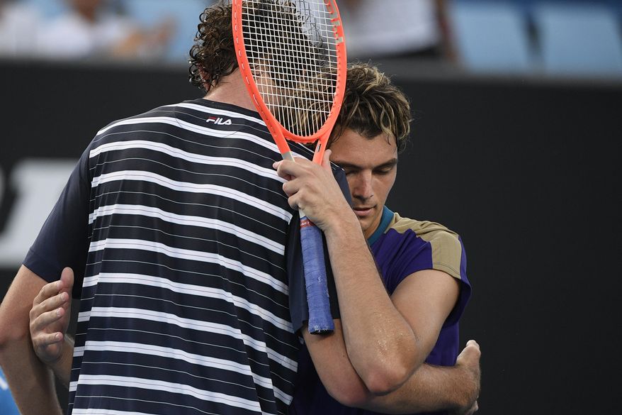 United States&#39; Taylor Fritz is congratulated by compatriot Reilly Opelka after their second round match at the Australian Open tennis championship in Melbourne, Australia, Wednesday, Feb. 10, 2021. (AP Photo/Andy Brownbill)